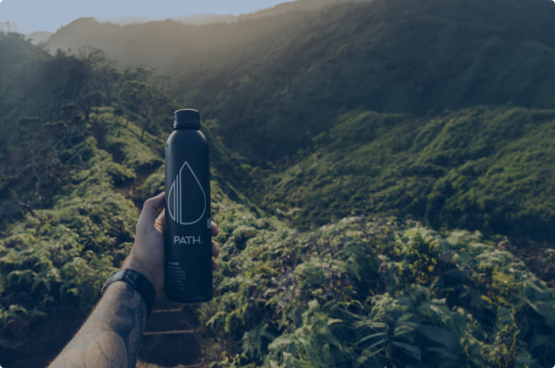 black bottle in rainforest mountains