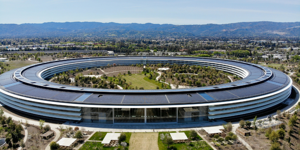 Aerial view of a circular corporate campus with solar panels and a landscaped central courtyard