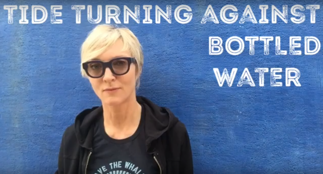 Belinda Waymouth standing against a blue wall with the overlaid headline Tide Turning Against Bottled Water
