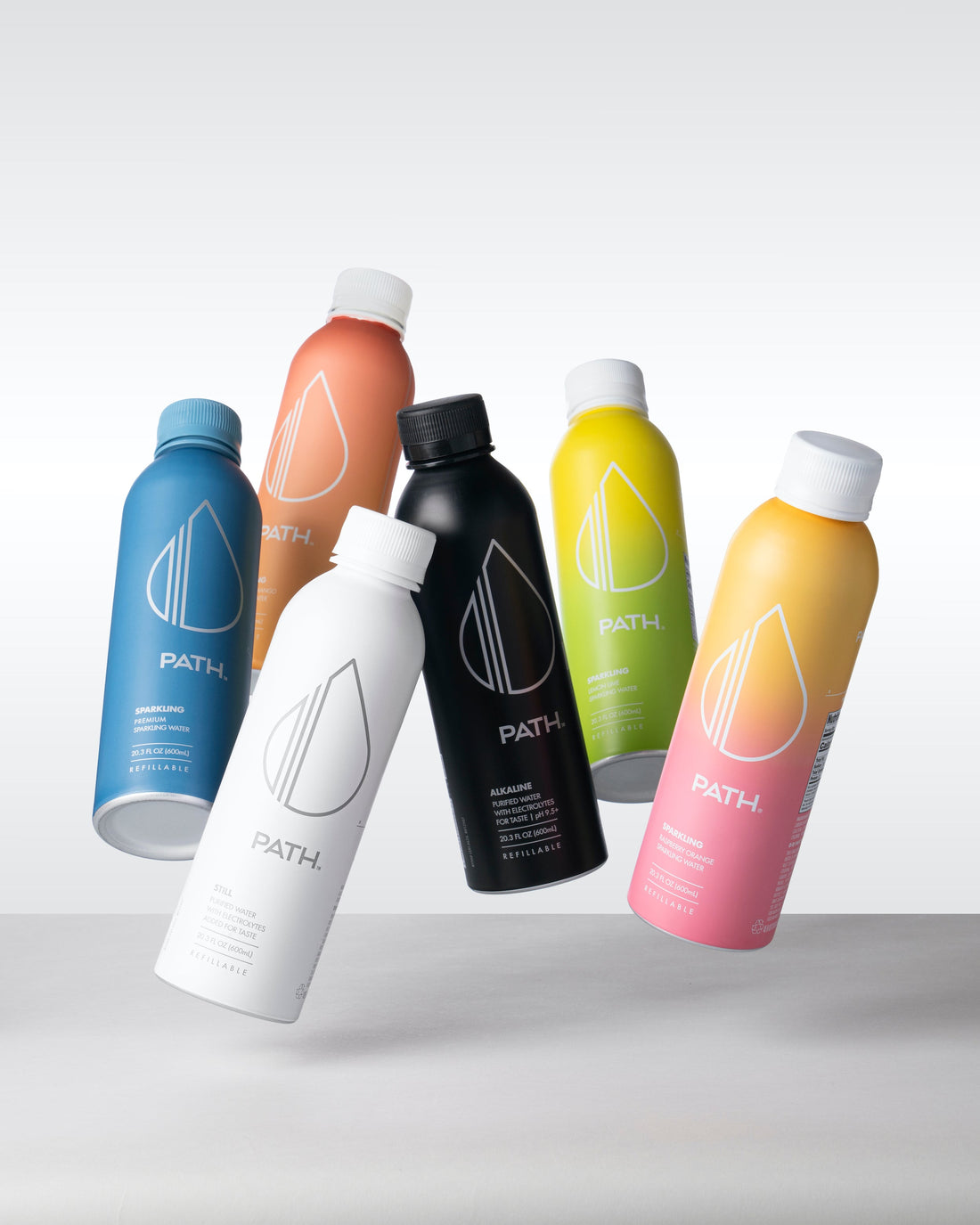 Group of six PATH refillable water bottles in assorted colors floating on a light gradient background