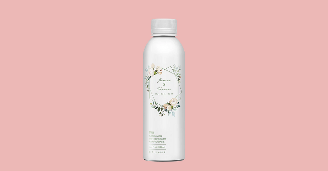 Front view of PATH custom aluminum bottle showing floral wedding label reading James & Vivian, May 27, 2024 on pink background