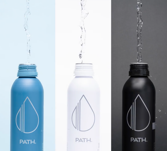 Front view of three PATH aluminum bottles (blue, white, black) with open tops being filled with water