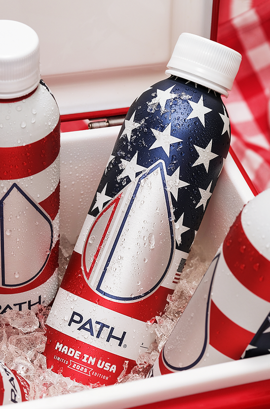 Close-up of PATH aluminum water bottle with American stars-and-stripes design and MADE IN USA label in ice-filled cooler